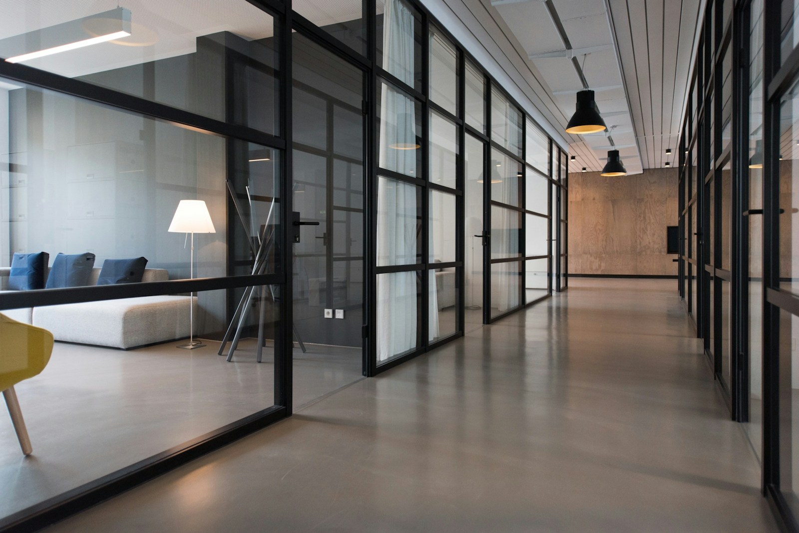 Sunlit modern workplace with shared desks and meeting spaces